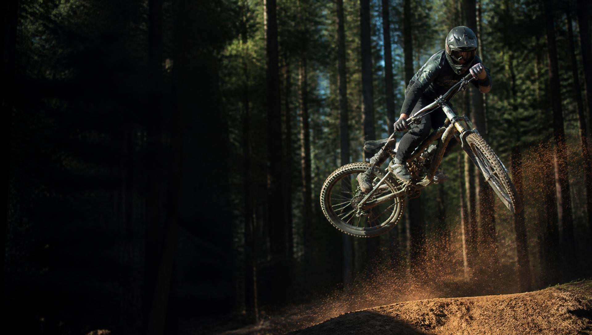 Mountain biker sending a forest jump